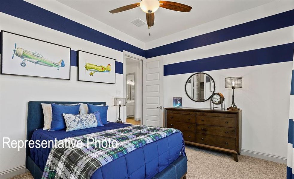 Bedroom featuring carpet flooring, painted striped accent walls, a paneled door, and a ceiling fan with integrated lighting Bedroom featuring carpet flooring, painted striped accent walls, a paneled door, and a ceiling fan with integrated lighting