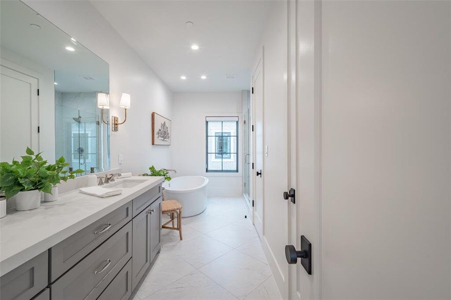 Bathroom featuring vanity and independent shower and bath