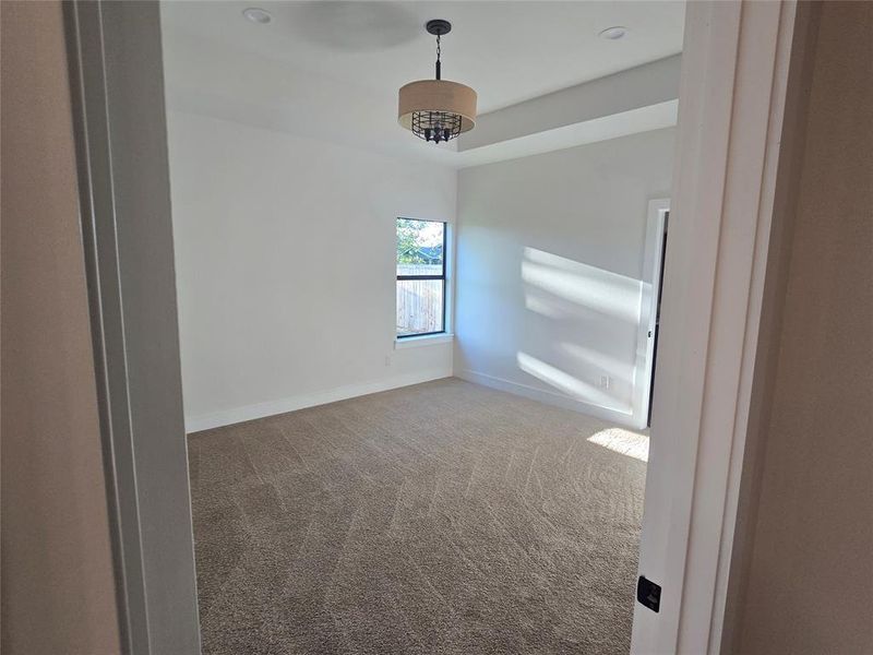 Carpeted spare room with baseboards