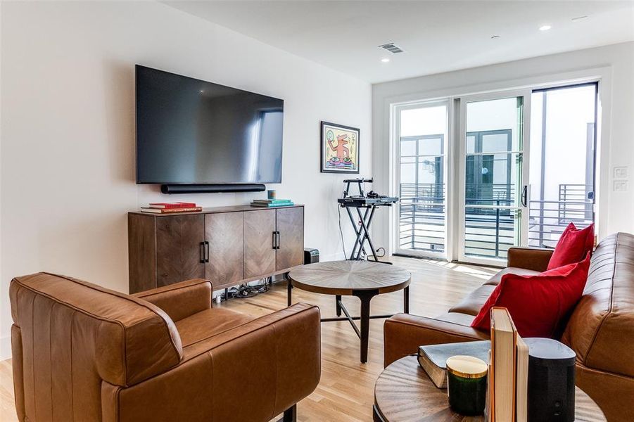Living area featuring light wood-style floors and recessed lighting Living area featuring light wood-style floors and recessed lighting