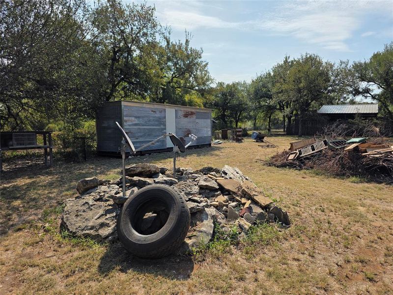 View of yard with a shed and view of wooded area View of yard with a shed and view of wooded area