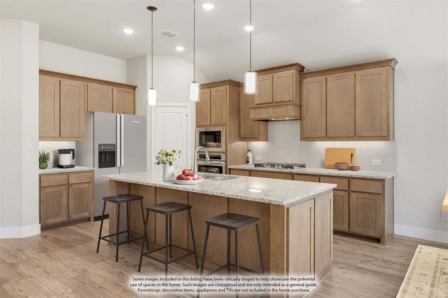 Kitchen with light wood cabinets, large island with granite countertop, pendant lights, and stainless steel appliances