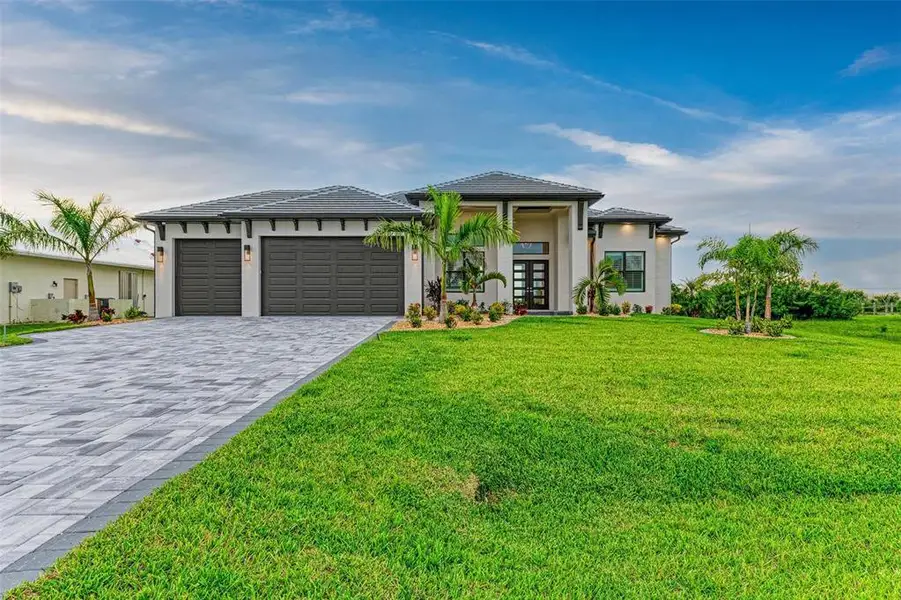Front exterior of a new home in , Port Charlotte, FL, highlighting curb appeal (Image 1). Front exterior of a new home in , Port Charlotte, FL, highlighting curb appeal (Image 1).
