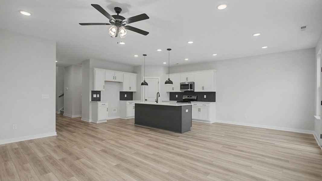 Open-concept first floor with living room near the kitchen and dining area