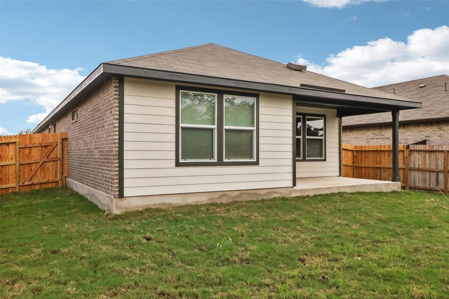 Rear view of house with a patio and brick siding Rear view of house with a patio and brick siding
