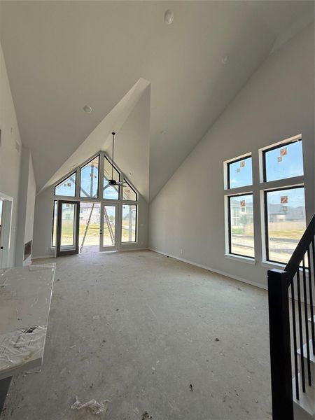 Soaring high ceilings in the family room boast a cathedral style ambiance, overlooking a massive backyard and relaxing covered patio.