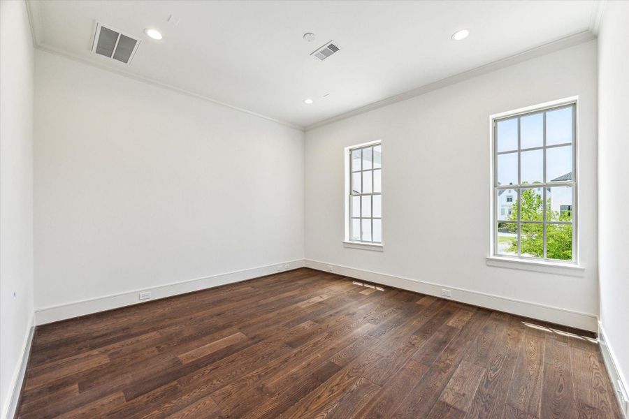 Light-filled Primary Suite with His and Hers walk-in closets and luxurious bath.
