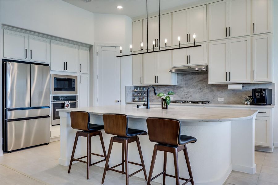 Gleaming stone countertops and matching custom cabinetry define this thoughtfully designed culinary workspace. Gleaming stone countertops and matching custom cabinetry define this thoughtfully designed culinary workspace.