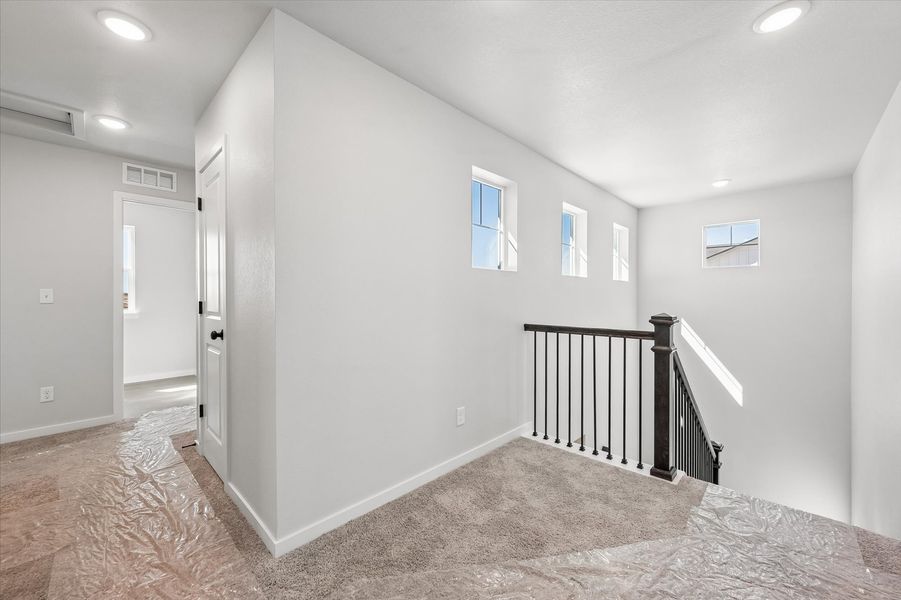 A hallway with white walls.