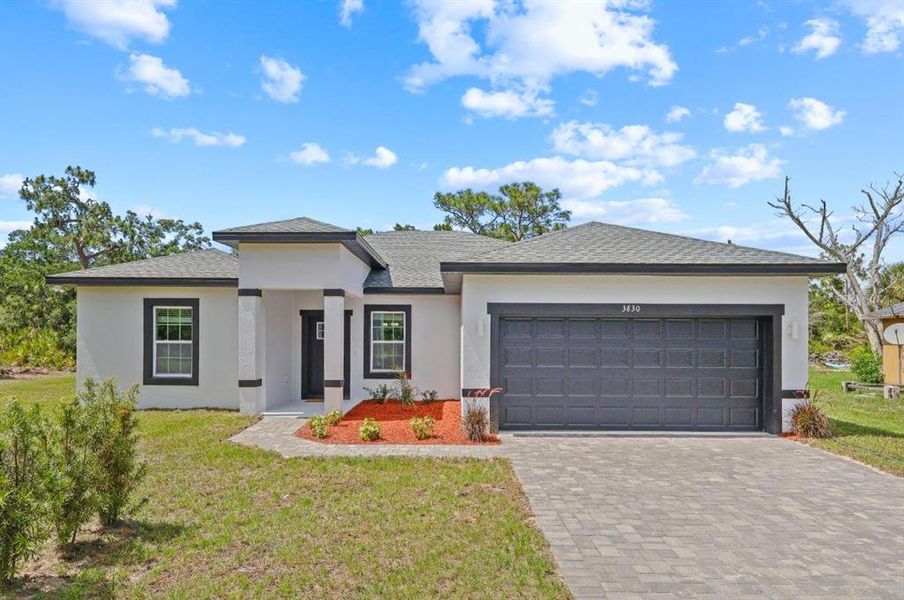 Front exterior of a new home in , Indian Lake Estates, FL, highlighting curb appeal (Image 1). Front exterior of a new home in , Indian Lake Estates, FL, highlighting curb appeal (Image 1).