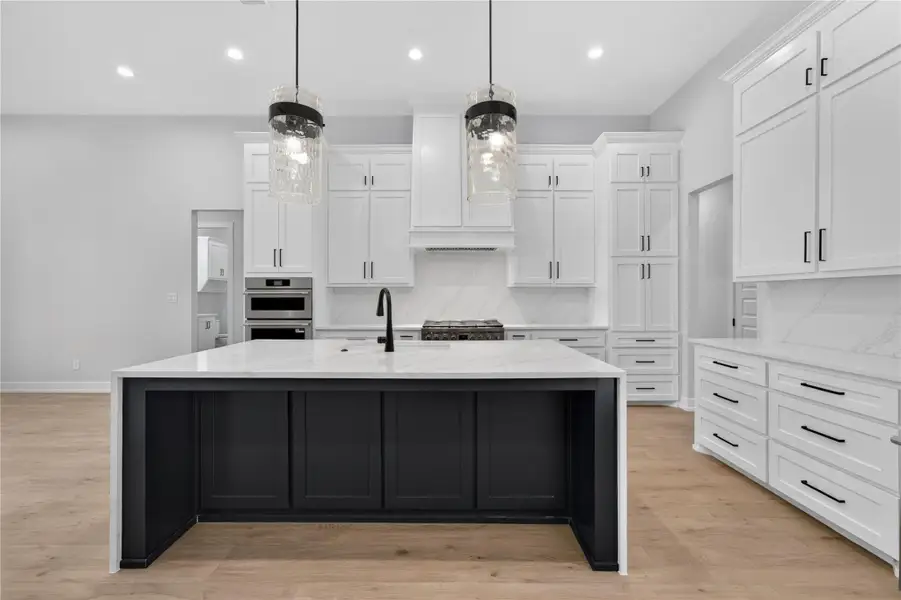 Clean lines and a spacious center island define this modern culinary space.
