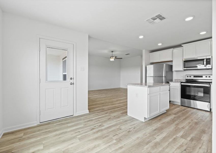 The dining room has a door that leads guest to the back patio