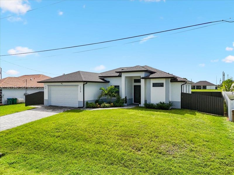 Front exterior of a new home in , Cape Coral, FL, highlighting curb appeal (Image 2). Front exterior of a new home in , Cape Coral, FL, highlighting curb appeal (Image 2).