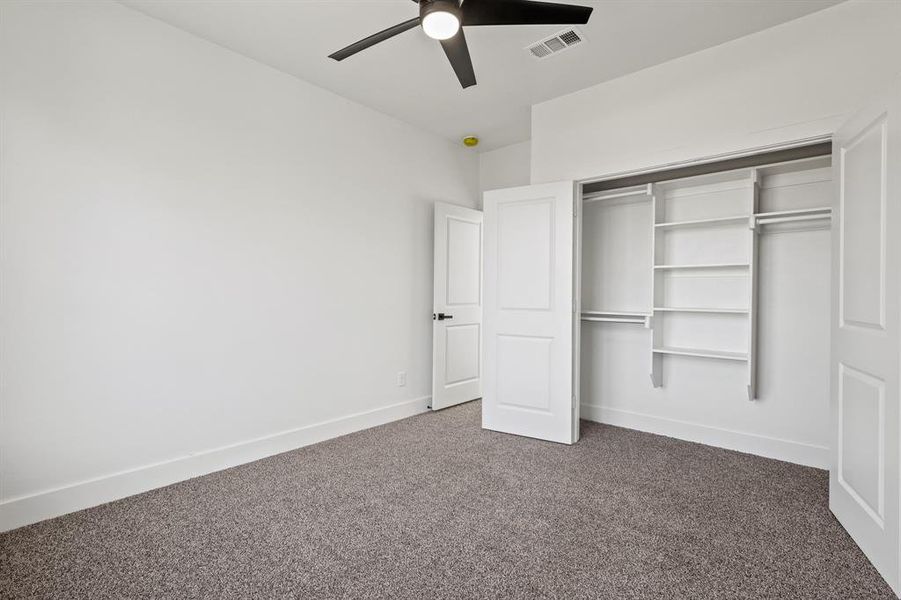 Unfurnished bedroom with carpet floors, a closet, and ceiling fan