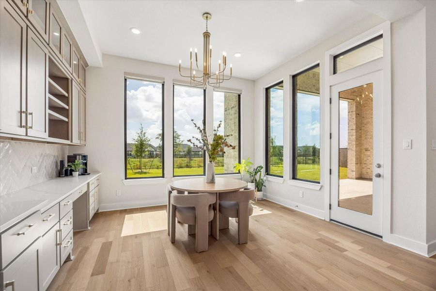 THE BREAKFAST AREA OFFERS GENEROUS NATURAL LIGHT, LARGE WINDOWS, AND DIRECT ACCESS TO THE COVERED PATIO. BUILT-IN CABINETRY AND CONTINUOUS WOOD FLOORING ADD BOTH FUNCTION AND STYLE. THE BREAKFAST AREA OFFERS GENEROUS NATURAL LIGHT, LARGE WINDOWS, AND DIRECT ACCESS TO THE COVERED PATIO. BUILT-IN CABINETRY AND CONTINUOUS WOOD FLOORING ADD BOTH FUNCTION AND STYLE.