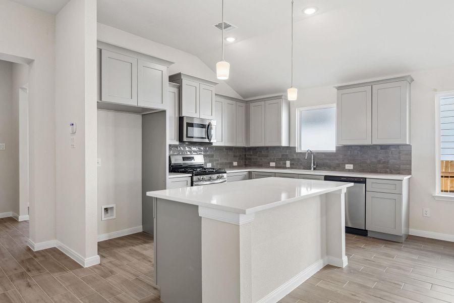 Clean lines and a spacious center island define this modern culinary space.