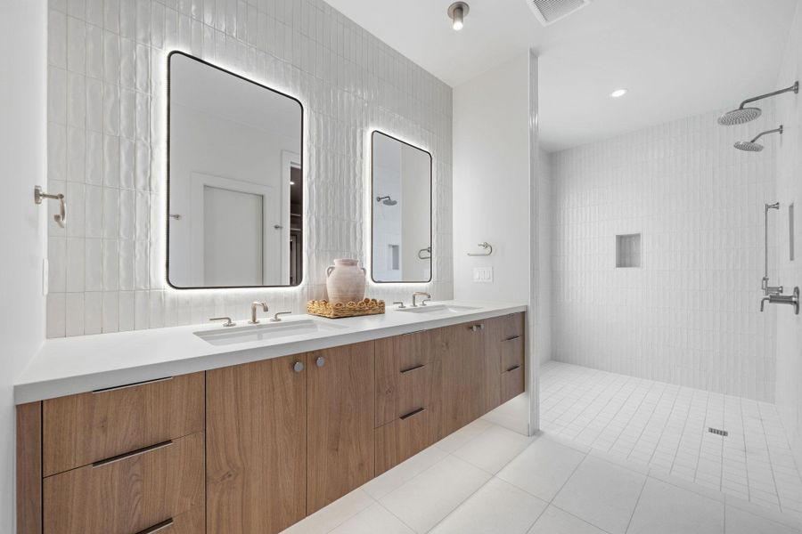 Indulge in a primary bathroom designed for serenity with a double vanity and an expansive walk-in shower.
