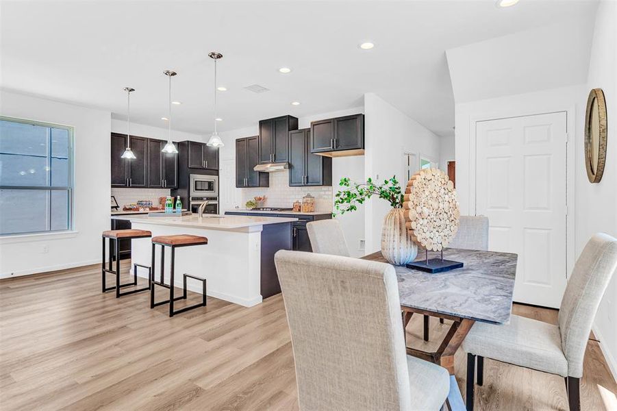 Dining room with sink and light hardwood / wood-style flooring