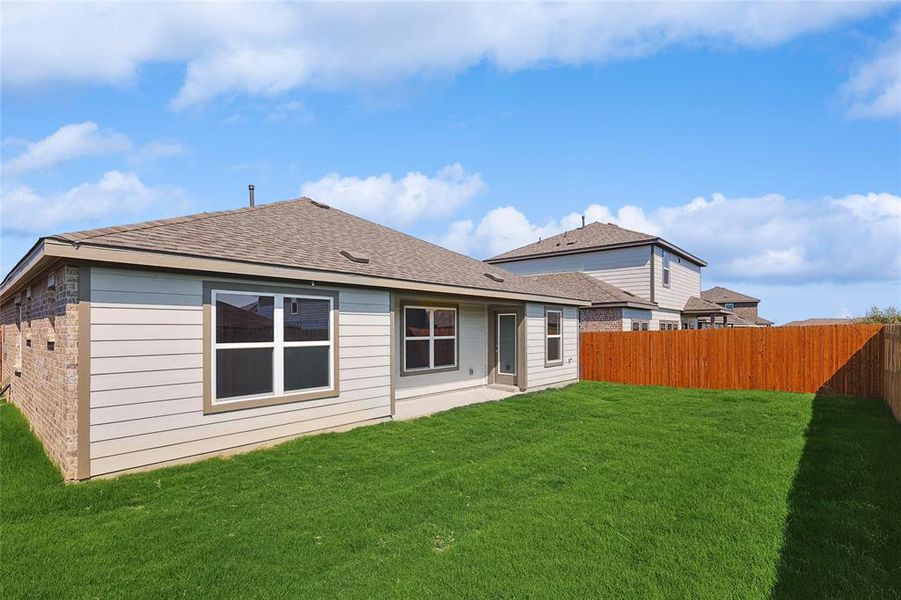 Rear view of house featuring a yard