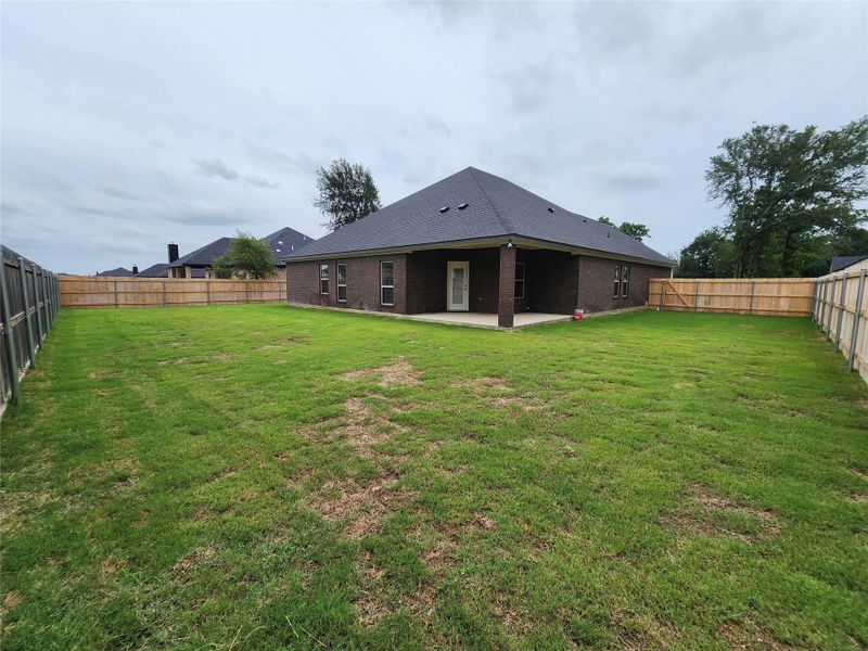 A fully fenced yard offers private outdoor living space for recreation and relaxation. A fully fenced yard offers private outdoor living space for recreation and relaxation.