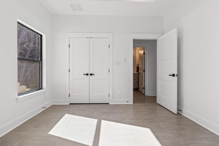 Unfurnished bedroom with a closet and baseboards