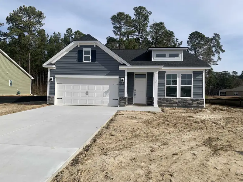 Front exterior of a new home in Beach Gardens, Conway, SC, highlighting curb appeal (Image 1). Front exterior of a new home in Beach Gardens, Conway, SC, highlighting curb appeal (Image 1).