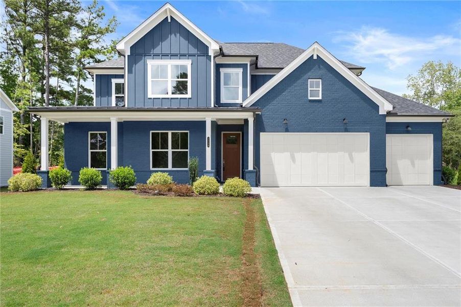 Front exterior of a new home in Hillgrove Preserve, Powder Springs, GA, highlighting curb appeal (Image 1).