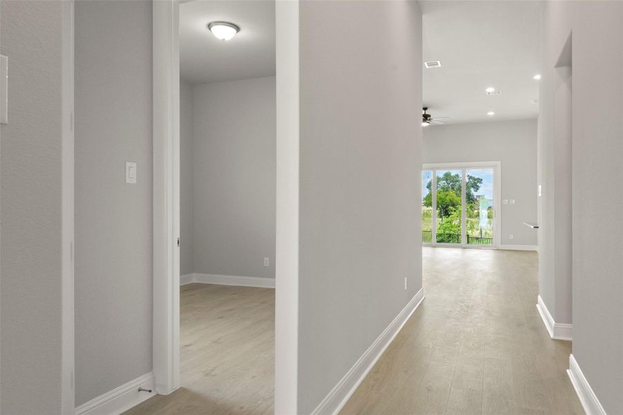 Hall featuring light wood-style floors and recessed lighting
