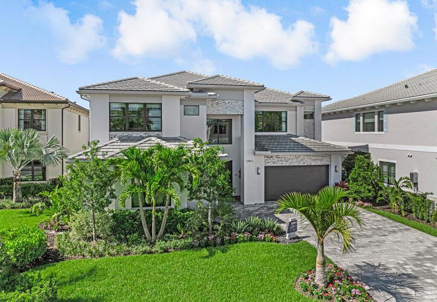 Front exterior of a new home in Apex at Avenir, Palm Beach Gardens, FL, highlighting curb appeal (Image 21).