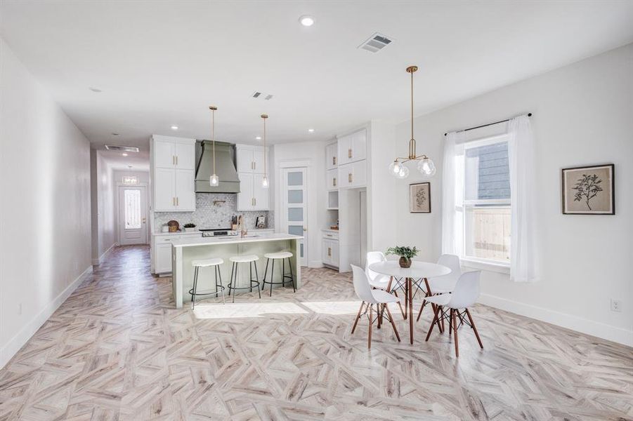 Dining area featuring light parquet flooring