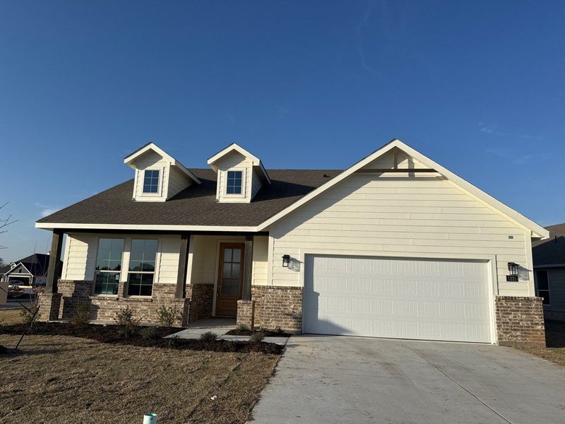 Front exterior of a new home in Covenant Park, Springtown, TX, highlighting curb appeal (Image 1). Front exterior of a new home in Covenant Park, Springtown, TX, highlighting curb appeal (Image 1).