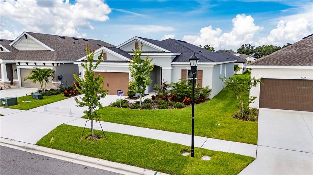 Front exterior of a new home in Waterset, Apollo Beach, FL, highlighting curb appeal (Image 27).