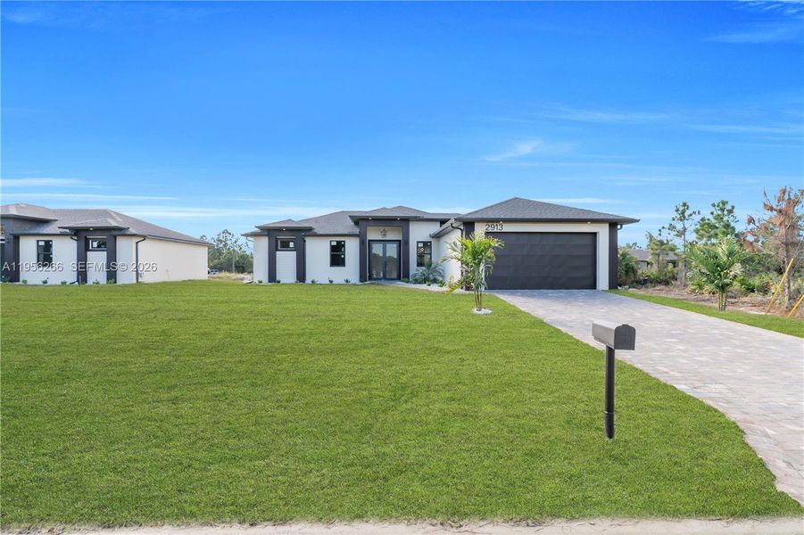 Front exterior of a new home in , Lehigh Acres, FL, highlighting curb appeal (Image 26).