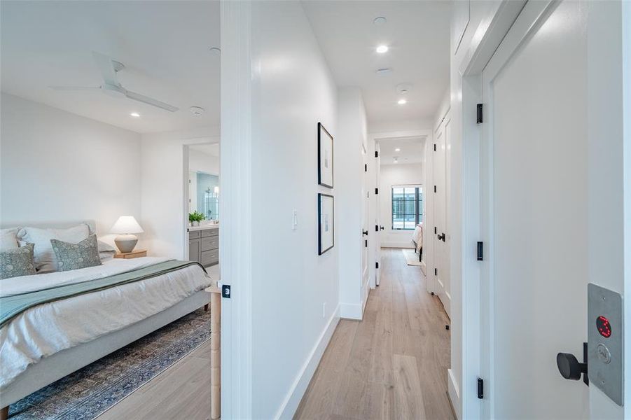 Hallway with light hardwood / wood-style flooring