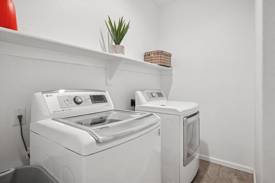 Laundry room with wood finished floors and room for full size washer and dryer. Laundry room with wood finished floors and room for full size washer and dryer.