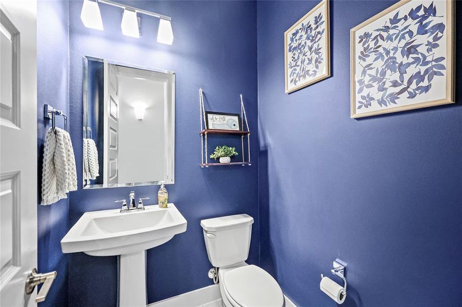 Guest powder room conveniently nestled in a secluded hallway near the home's entrance.