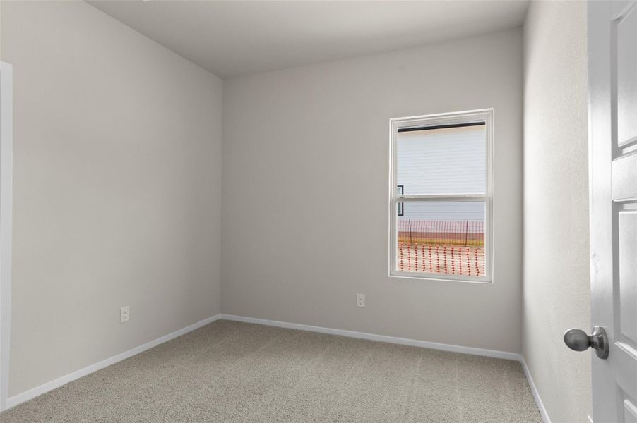 Carpeted empty room featuring baseboards Carpeted empty room featuring baseboards