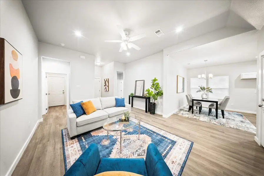 Living room with light wood-style floors, a chandelier, a ceiling fan, and recessed lighting Living room with light wood-style floors, a chandelier, a ceiling fan, and recessed lighting