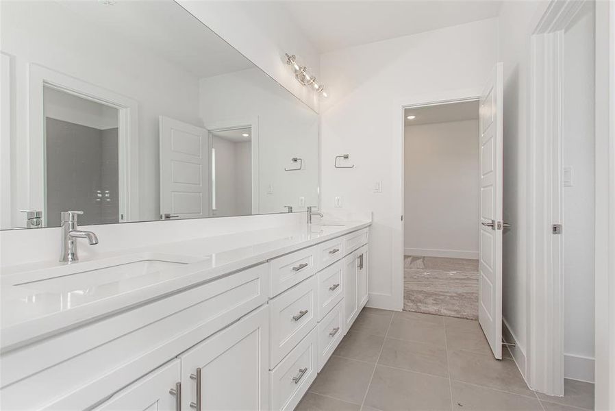 Bathroom featuring dual vanity and tile patterned flooring