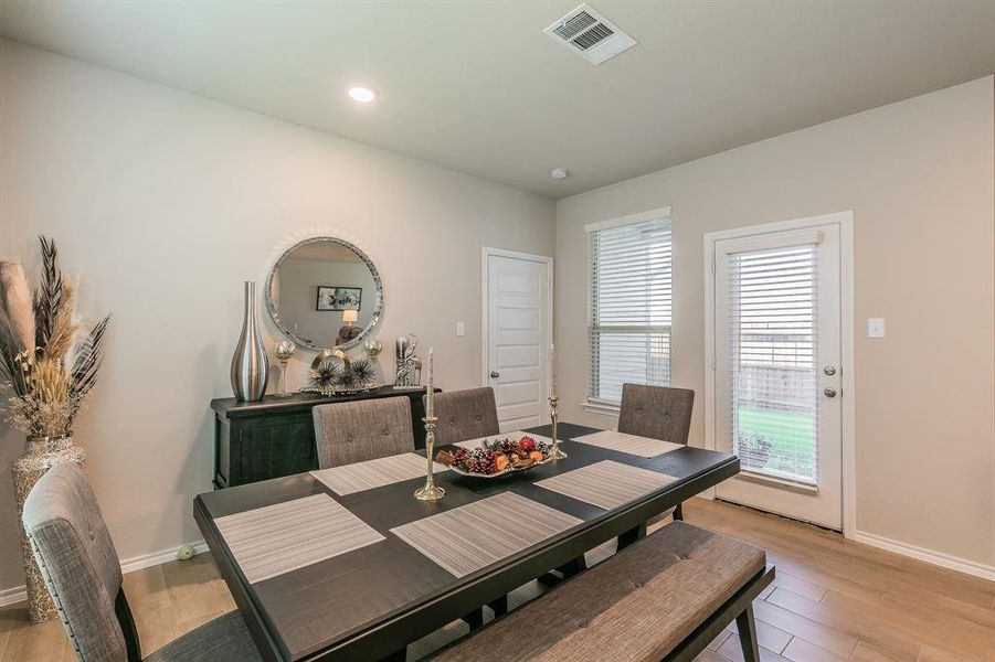 Dining space featuring light wood-type flooring and recessed lighting