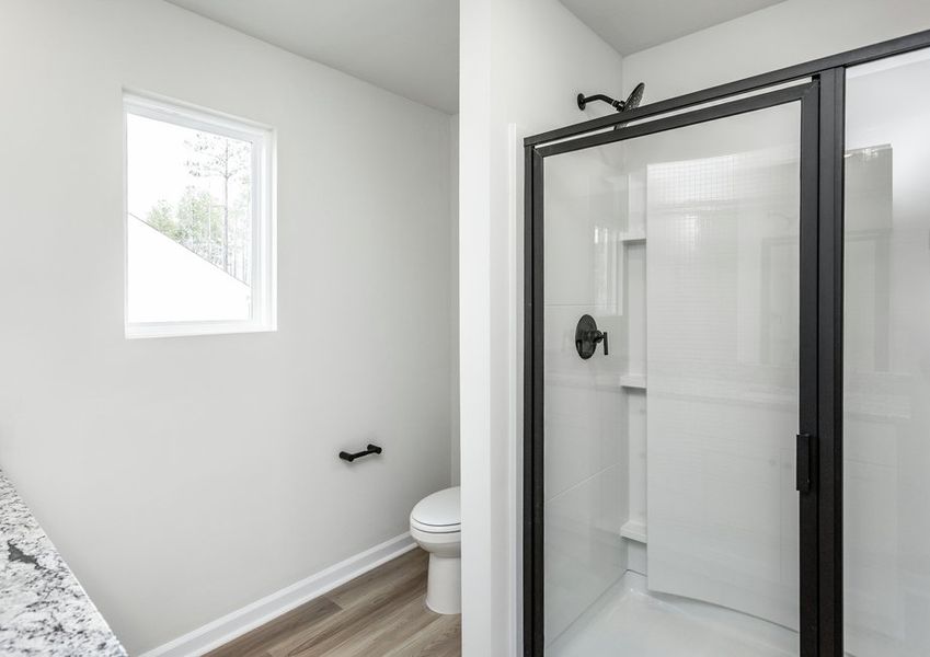 The master bathroom features a glass-enclosed shower. The master bathroom features a glass-enclosed shower.