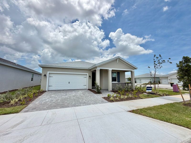 Front exterior of a new home in Crescent Lakes - Reserve Series, Punta Gorda, FL, highlighting curb appeal (Image 8). Front exterior of a new home in Crescent Lakes - Reserve Series, Punta Gorda, FL, highlighting curb appeal (Image 8).