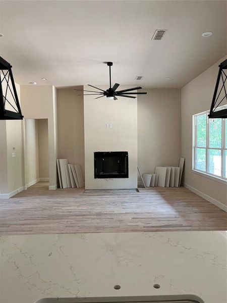 Living room has 12-foot ceilings, can lights, gas log brick fireplace, hardwood floors, wall of windows overlooking back porch. Living room has 12-foot ceilings, can lights, gas log brick fireplace, hardwood floors, wall of windows overlooking back porch.