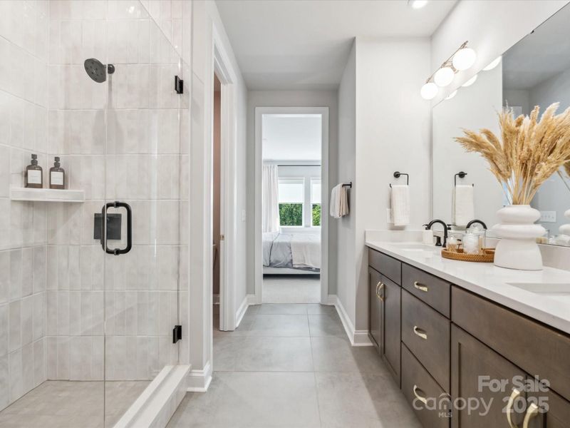 En suite bath complete with dual vanity and huge walk-in shower. *Model Photos | Actual orientation, structural selections, and finishes may vary. En suite bath complete with dual vanity and huge walk-in shower. *Model Photos | Actual orientation, structural selections, and finishes may vary.