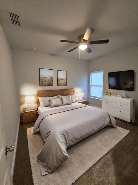 Bedroom featuring ceiling fan and carpet floors