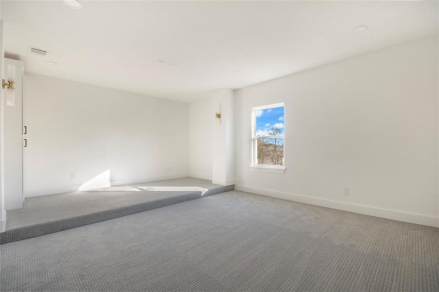 Spare room featuring baseboards and carpet Spare room featuring baseboards and carpet