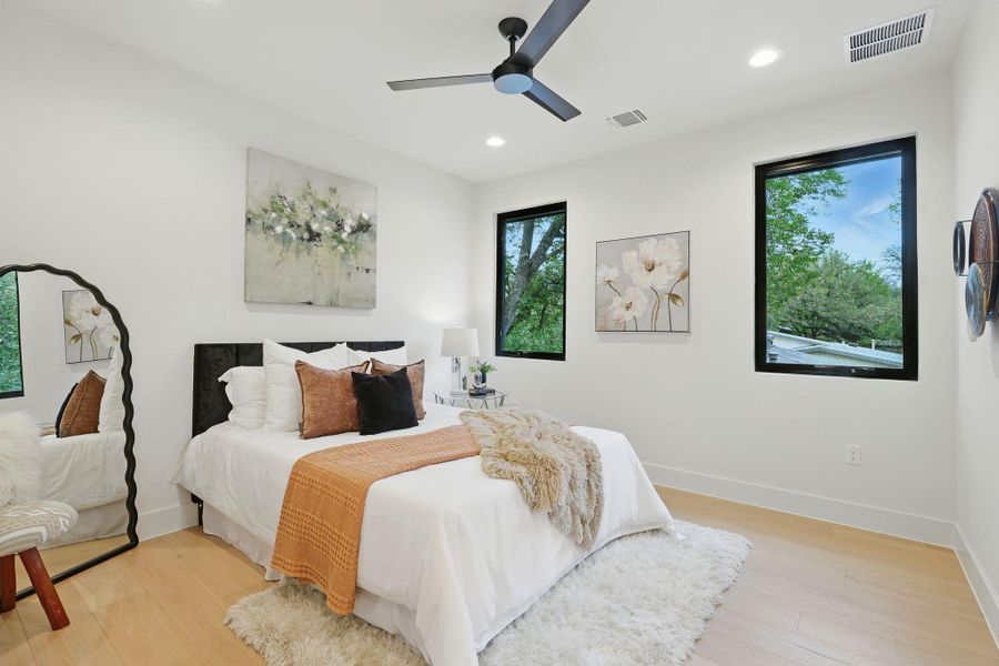 Bedroom with light wood-style flooring, recessed lighting, and a ceiling fan