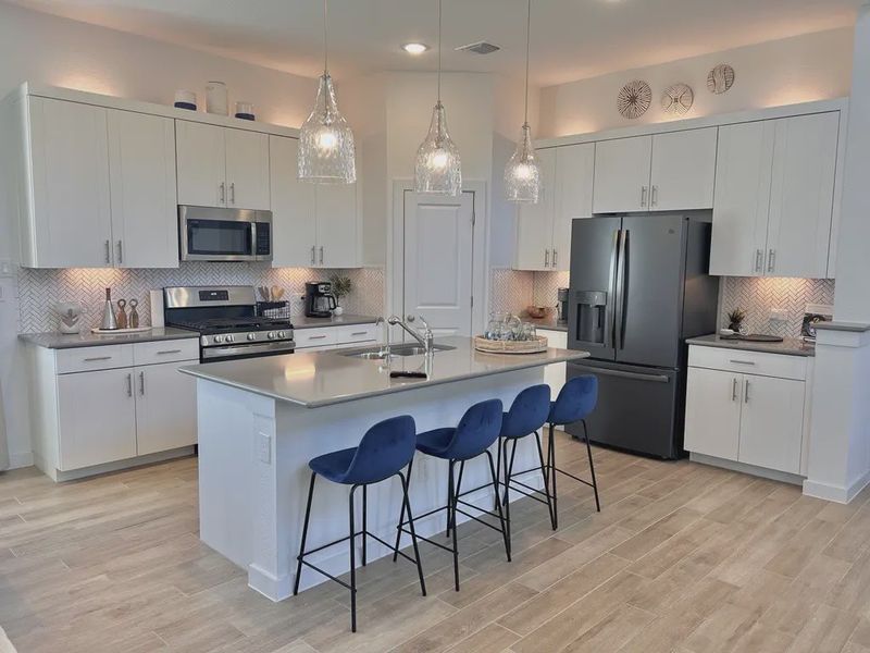 Representative furnished interior of a home built from the Saxony by Chesmar Homes in Sunterra, Katy (Image 4).