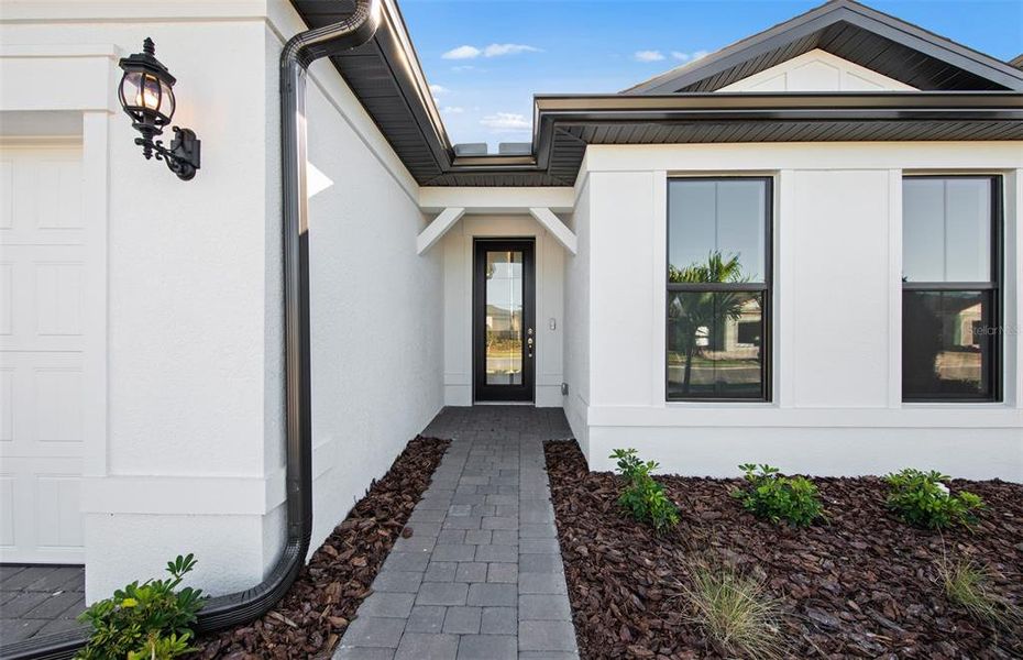 Exterior details and patio area of a home in Cedar Grove at The Woodlands, North Port (Image 21).