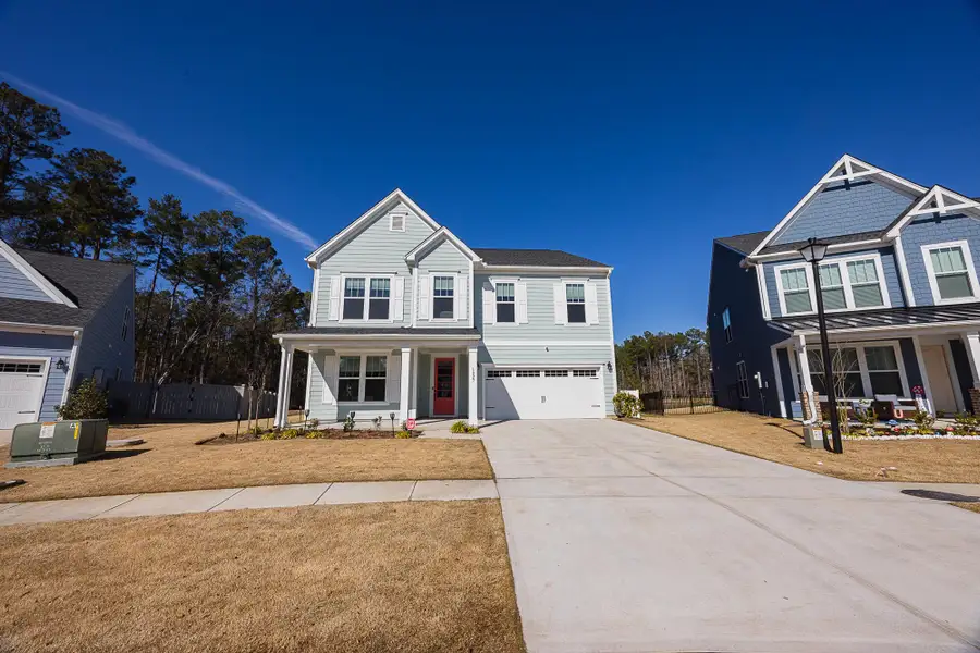 Front exterior of a new home in , Ravenel, SC, highlighting curb appeal (Image 25).